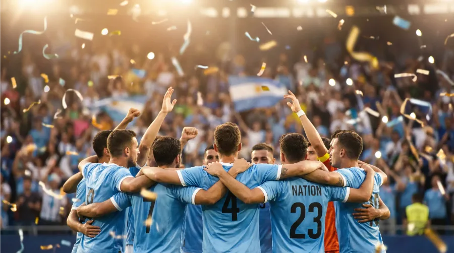 Nationalmannschaft feiert einen Treffer mit erhobenen Armen vor jubelnden Fans im Stadion